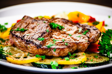Grilled steak with potatoes and vegetable salad