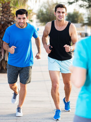 Two sportsmen jogging in park