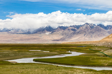 Tagharma viewing deck panorama on Pamir Plateau, at the feet of Muztagh Ata, China. This wetland is a bird paradise along the famous Karakorum highway, which has some of the best views of China