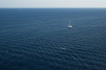 simple scenery landscape pattern summer cruise vacation concept of single walking yacht in water environment in Mediterranean sea not far from Greece coast line, copy space in aerial photography