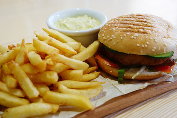 Small hamburger, french fryes and bowl of souse