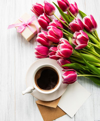 Cup of coffee and pink tulips