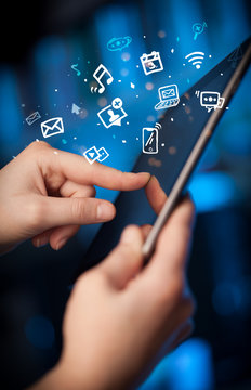 Hand holding tablet with drawn multimedia and application icons
