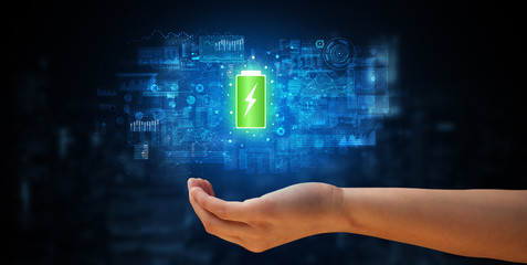 Elegant hand holding battery with full of energy
