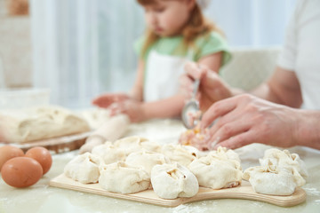 Uzbek national food manta, like dumplings, puts ingredients with a man's hand. selective control focus