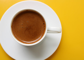 Cup of coffee on color background