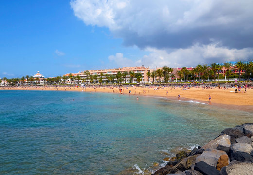 Beautiful coastal view of Playa del Camison beach with turquoise water and yellow sand in Las Americas, Tenerife,Canary Islands,Spain.Travel or vacation concept.