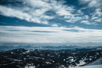 View over a valley in Austrian Alps. Photographed from slope in Turracher Hoehe in February. Winter wonderland.