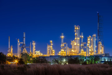 Plakat night after sunset time with agriculture field and chemical plant petrochemical and petroleum plant with reactor and distillation for chemical process in industrial area