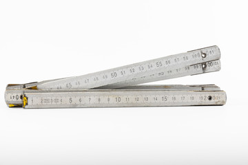 Folding wooden meter on a white background