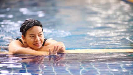 Asia women swimming .She is a happy exercise.