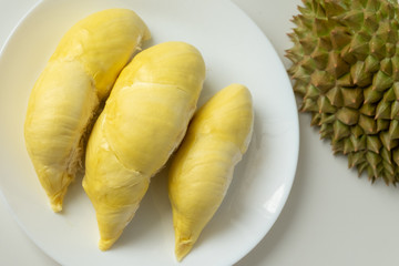 Top view of fresh cut Durian and pulp of Durian yellow color on dish isolated on white background
