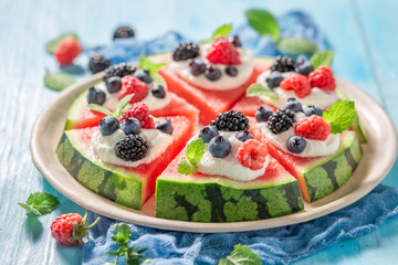 Juicy watermelon pizza with blueberries, raspberries and cream