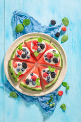 Tasty watermelon pizza with whipped cream and fresh berry fruits