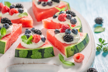 Delicious watermelon pizza with blueberries, raspberries and cream