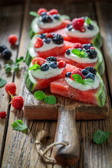 Sweet watermelon pizza with whipped cream and fresh berry fruits