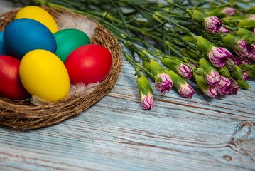 Fototapeta na wymiar colorful Easter eggs on blue wooden background