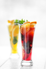 Refreshing healthy drinks with mint and citrus and pomegranate on a white background.Refreshing cold cocktails with mint and citrus and pomegranate on a white background. Concept for drinks, summer