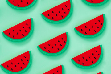 Pattern of many watermelon slices aon green background. Creative concept of luxury relax with fruit in the tropics.  Minimalism