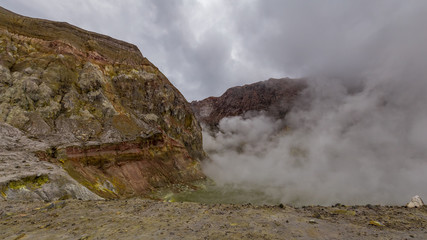 Standing on the edge of the active vents in the crater of White Island Volcano, Bay of Plenty, New Zealand.