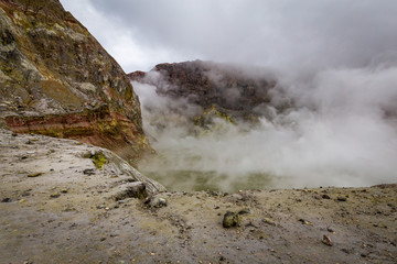 Standing on the edge of the active vents in the crater of White Island Volcano, Bay of Plenty, New Zealand.