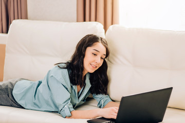 Bbeautiful woman using laptop computer at home on sofa