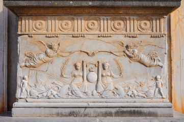 Marble relief with angels and heralds on the main facade of the Palace of Charles V inside the Alhambra. Granada, Spain