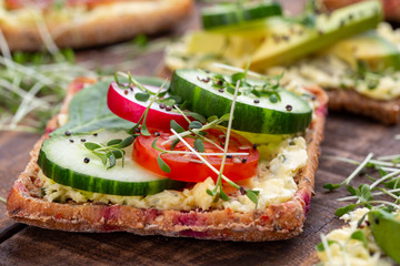 Sandwiches with cream cheese, vegetables and salami.