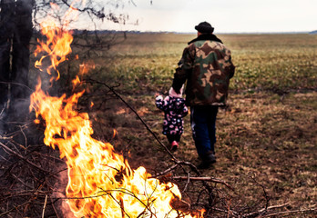 Naklejka premium Fire in forest. Natural disaster. Rescue child from fire.