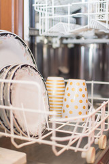 Fototapeta na wymiar Open dishwasher with clean dishes.