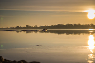 Obraz na płótnie Canvas Boat on the river at sunset.