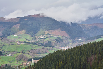 Beautiful landscape with mountain, green fields and rural village in the Basque Country, Spain. The little Swiss