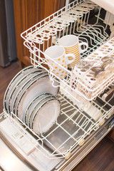 Open dishwasher with clean dishes.