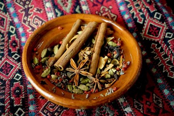 Fototapeta premium Ceramic bowl on arabic fabric with mixed spices