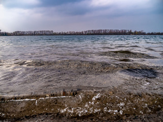 amazing seeshore, with a wave hitting the gravel beach