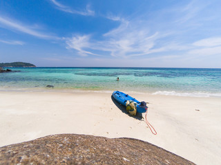 Fototapeta na wymiar woman with a kayak on an isolated beach in Andaman sea, Koh Lipe - solo travel