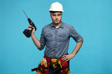 People, repair, equipment and renovation concept. Stylish young Caucasian repairman wearing...