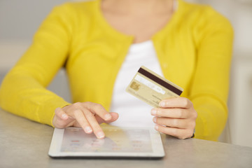 cropped image of woman making online purchase on a tablet