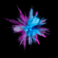 Colored powder explosion. Abstract closeup dust on backdrop. Colorful explode. Paint holi