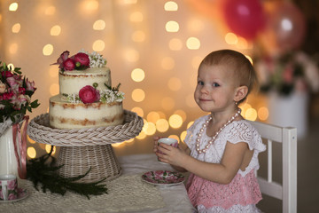 child tastes cake decorated with lively flowers