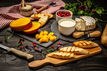 Toasts of cheese, Alphonso mango. Bruschetta with mango and cheese. Homemade. Healthy vegetarian nutritionon a wooden background, Top view. Copy space