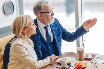 attractive gorgeous couple enjoying time at the restaurant. close up side view photo. love, leisure time