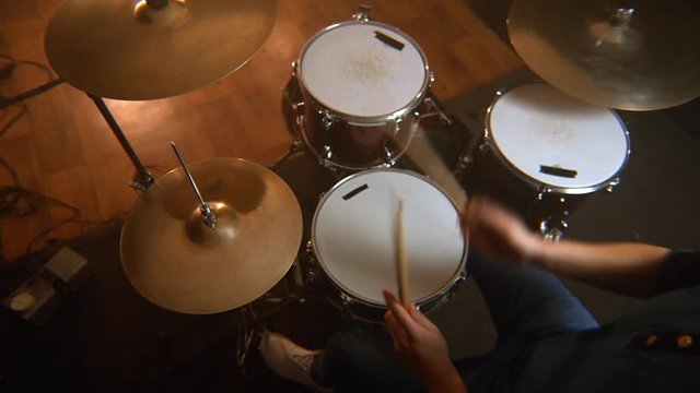 male drummer, a lesson of jazz training on the drum set in the rehearsal room