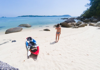 Fototapeta na wymiar woman with a kayak on an isolated beach in Andaman sea, Koh Adang - solo travel