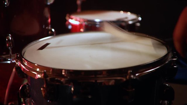 drummer, jazz lesson drumroll, classic grip of brushes drumsticks on a snare  a rehearsal studio on a red drums , low key, close-up