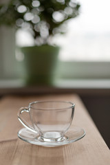 Top view of an empty glass cup on the wooden table.