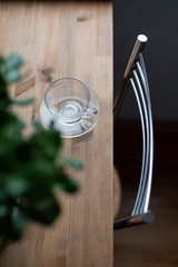 Top view of an empty glass cup on the wooden table.