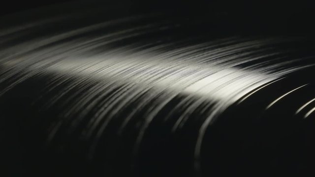 Spinning professional vinyl record in soft light, seamless loop footage. View from above, more options in my portfolio