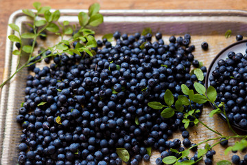 Lots of blueberries on a vintage iron tray on the table. Jam, summer, Breakfast