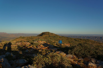 Fototapeta na wymiar man hiking at the top of Mount Sonder just outside Alice Springs, West MacDonnel National Park, Australia
